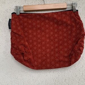 twig & horn packing bag.  Brick red with geometric pattern.
